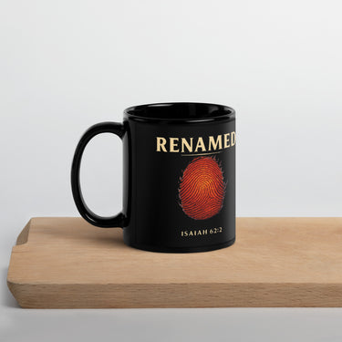 Renamed Black Glossy Mug 11oz front side showing fingerprint design in gold on matte black ceramic
